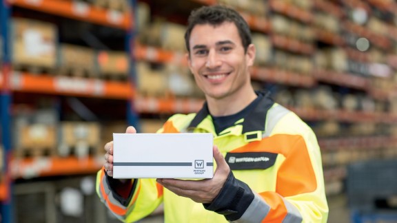Service technician holding a WIRTGEN GROUP package