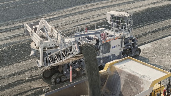 The Surface Miner cuts the limestone and loads it into trucks driving alongside the machine.