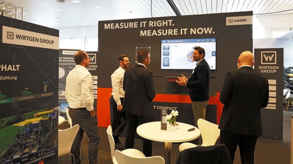 Industry specialists chatting at the special exhibition booth at the show