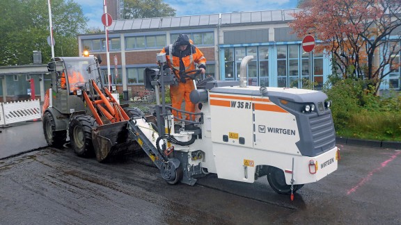 A Wirtgen small milling machine W 35 Ri milling off the surface layer.