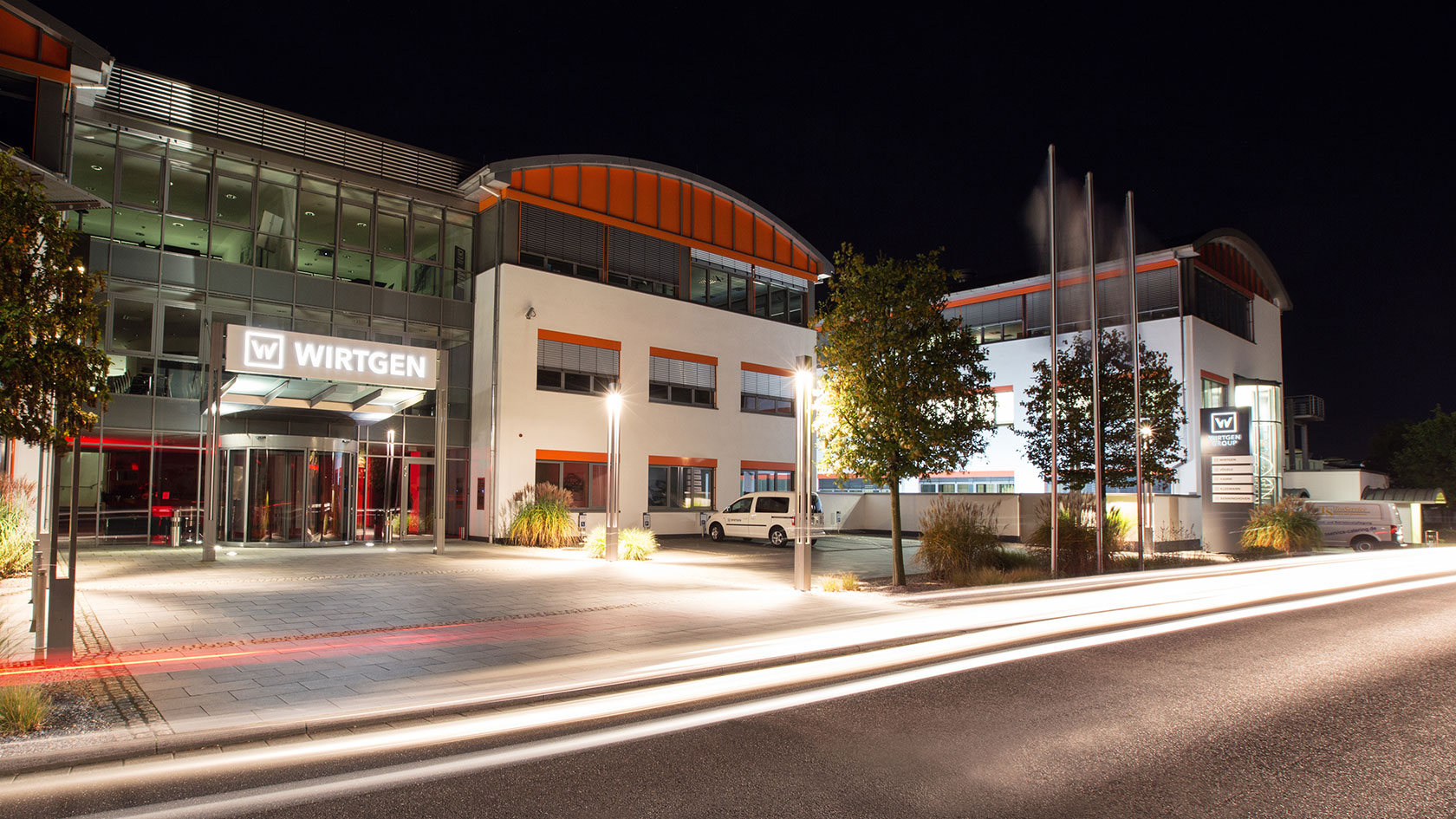 Entrance to the Wirtgen GmbH factory in the dark with light trail effects