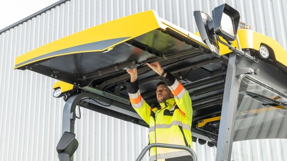 The picture shows a PowerFeeder with the hardtop raised to provide shade from the sun.