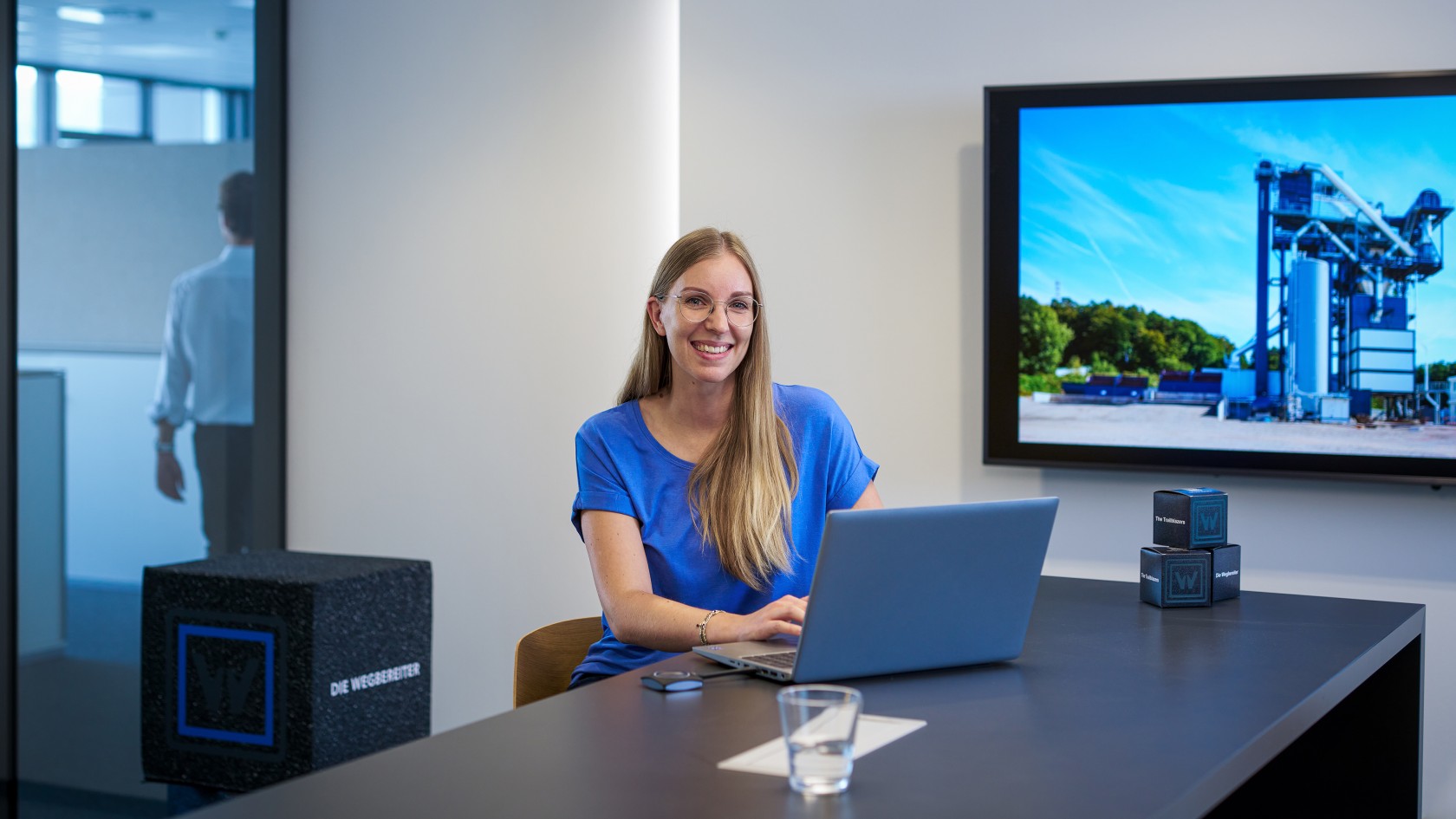 Portrait of a student working on a laptop in a meeting room