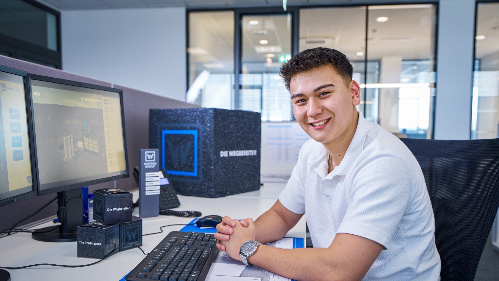 Portrait of an apprentice at their office workstation
