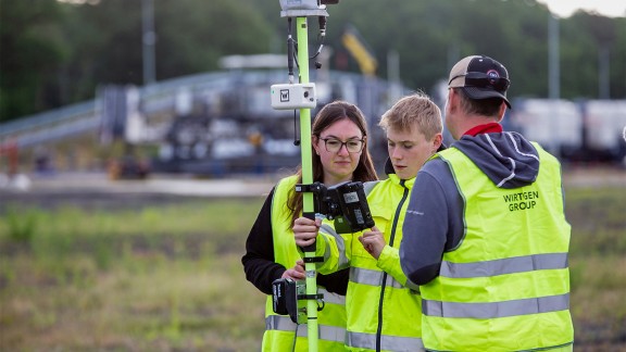 Trainees and an instructor surveying with a laser.