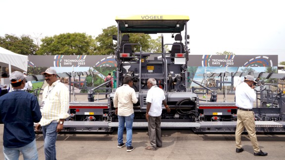 Participants in front of a Vögele paver