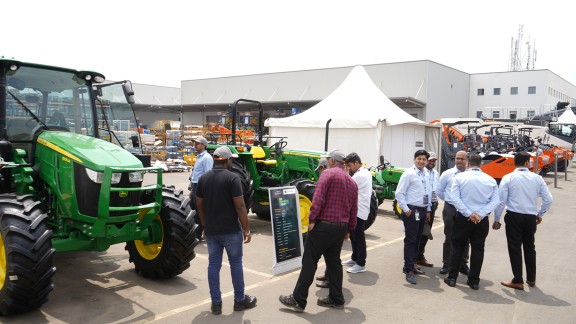 Participants looking at John Deer machinery