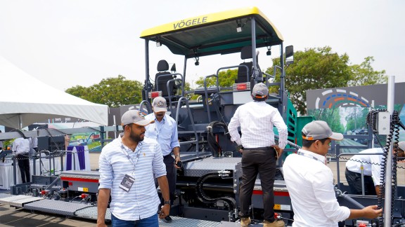 Participants in front of a Vögele paver