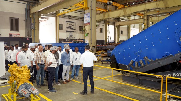 Participants taking part in a factory tour