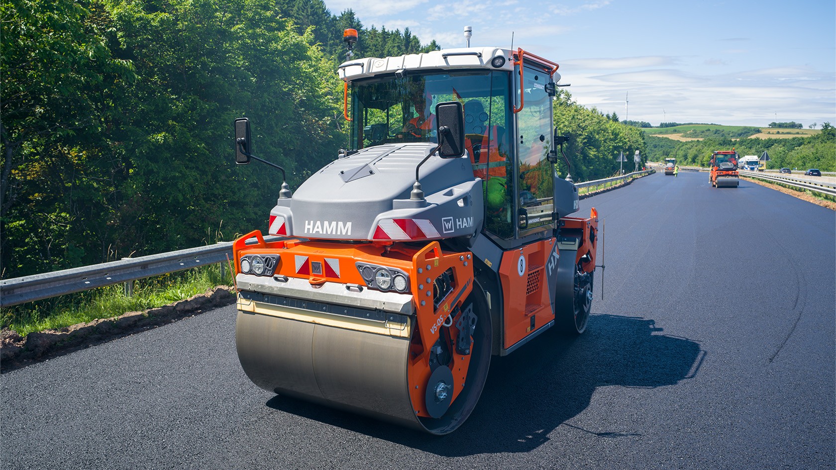 A roller consolidating the binder course.