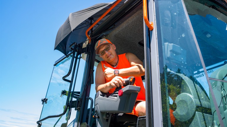 Smiling roller driver looking out of his machine.