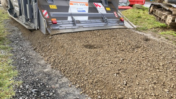 The binding agent was mixed together with the milled pavement of the damaged agricultural road.