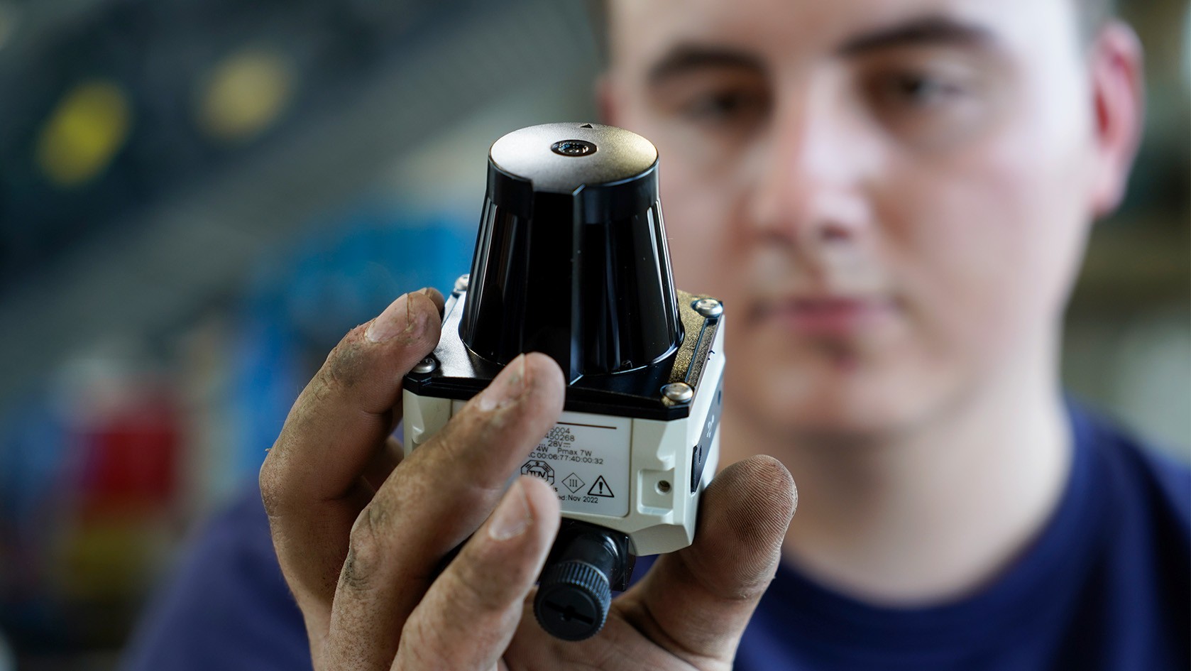 A man holds a component for the WPT retrofit in his hand