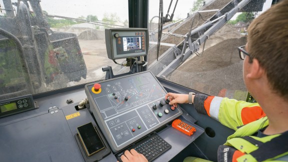 Employee working at a control panel.