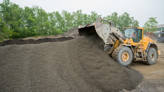 Wheel loader moving stockpiled mix.