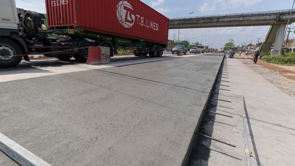 The Surat Thani project site; flowing traffic with a truck on the left-hand lane.