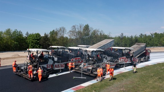 Vögele Pavers paving asphalt on a race track.
