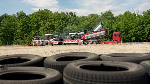 A thermally-insulated truck delivers the special asphalt.