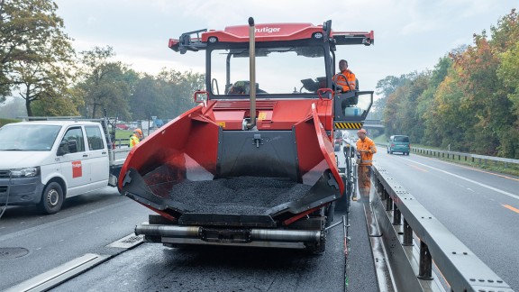 Front view of a paver with a large material hopper