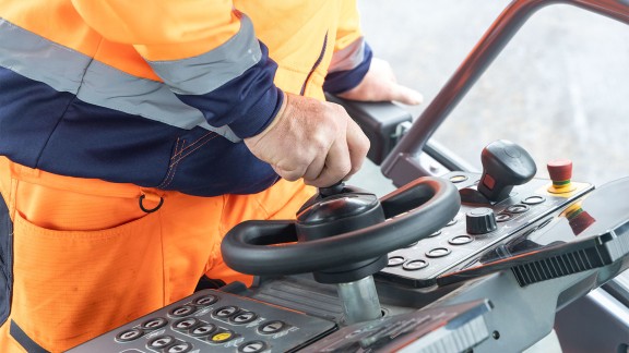 Close-up of steering wheel on the paver operator’s console.