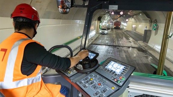 Operator using the steering wheel of the paver operator’s console
