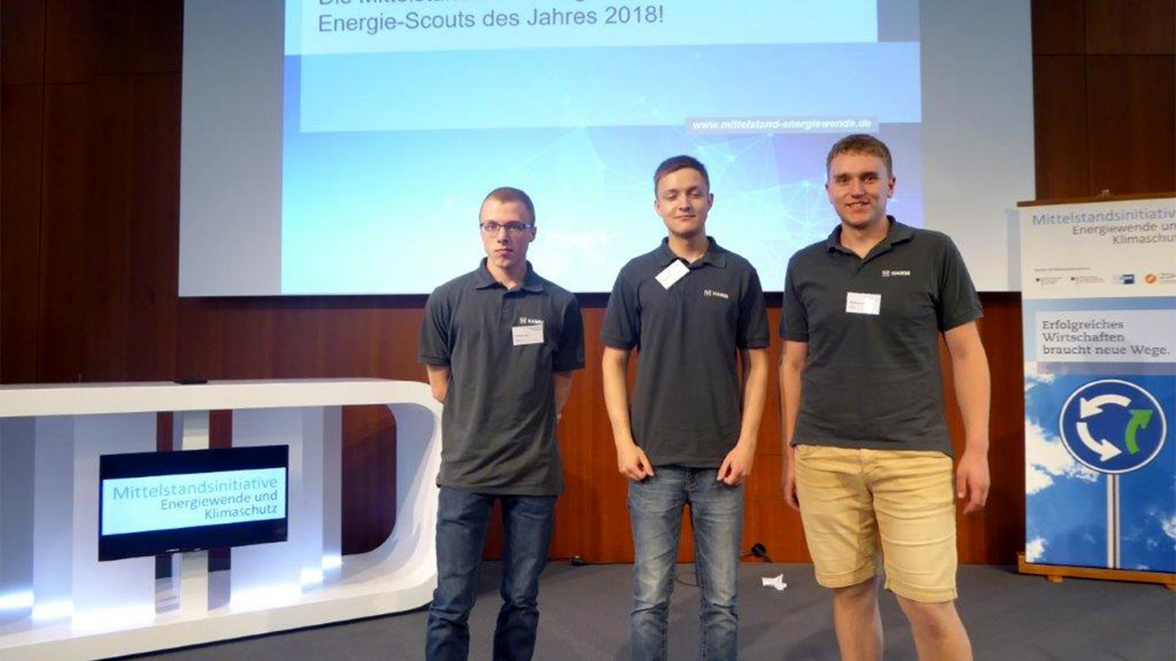 Three trainees are honored with prizes.