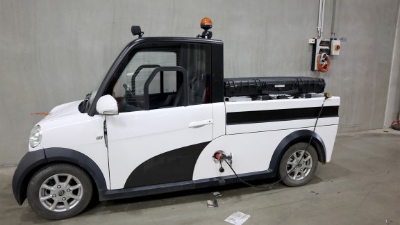 Small electric van against a grey wall