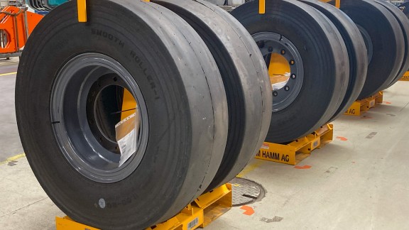 Pneumatic-tire rollers on transport racks