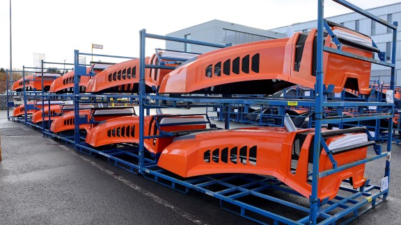 Machine parts stacked on transport racks