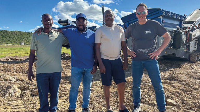 A satisfied team smiles into the camera.