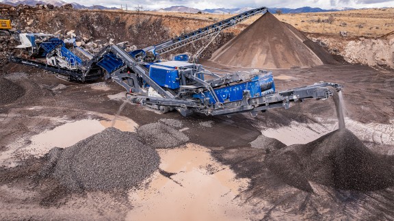 Oblique view from above: jaw crusher feeding the scalping screen, material transfer to cone crusher