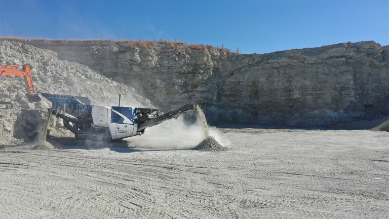 Kleemann plant on the left side of the photo in the sun-drenched quarry.