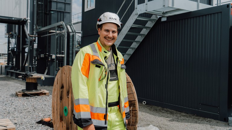 Niklas Koble, apprentice Electronics Technician, stands in front of the CORE.