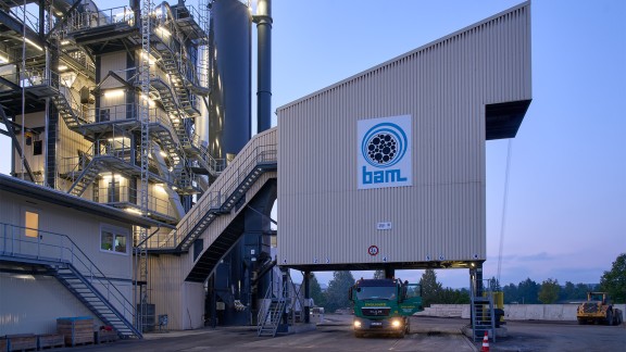View of the illuminated loading silo at dusk