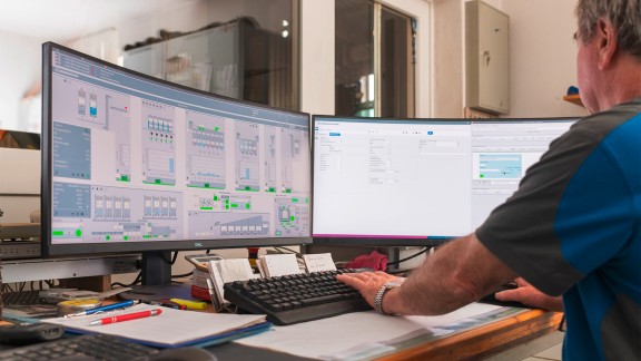 View of the computer screen over the user’s shoulder.